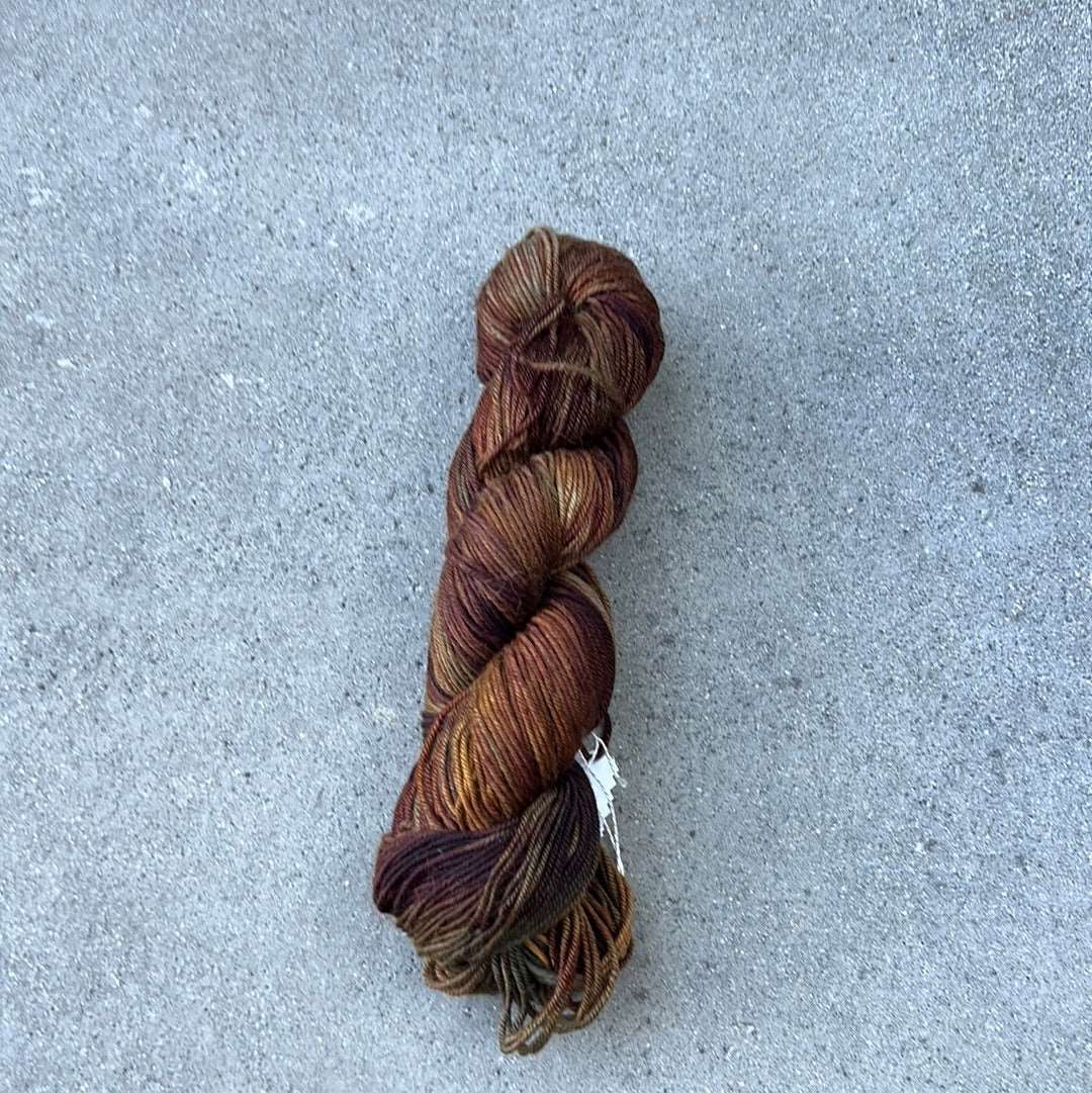 warm toned hand painted and hand dyed knitting yarn with tones of brown