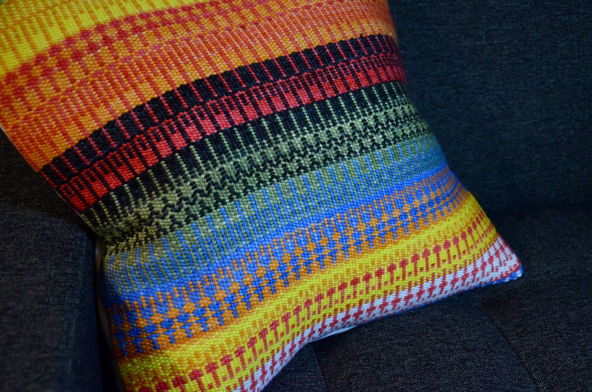 Handwoven throw pillow cover with bright and summer like warm tones of yellow, orange, green and blue