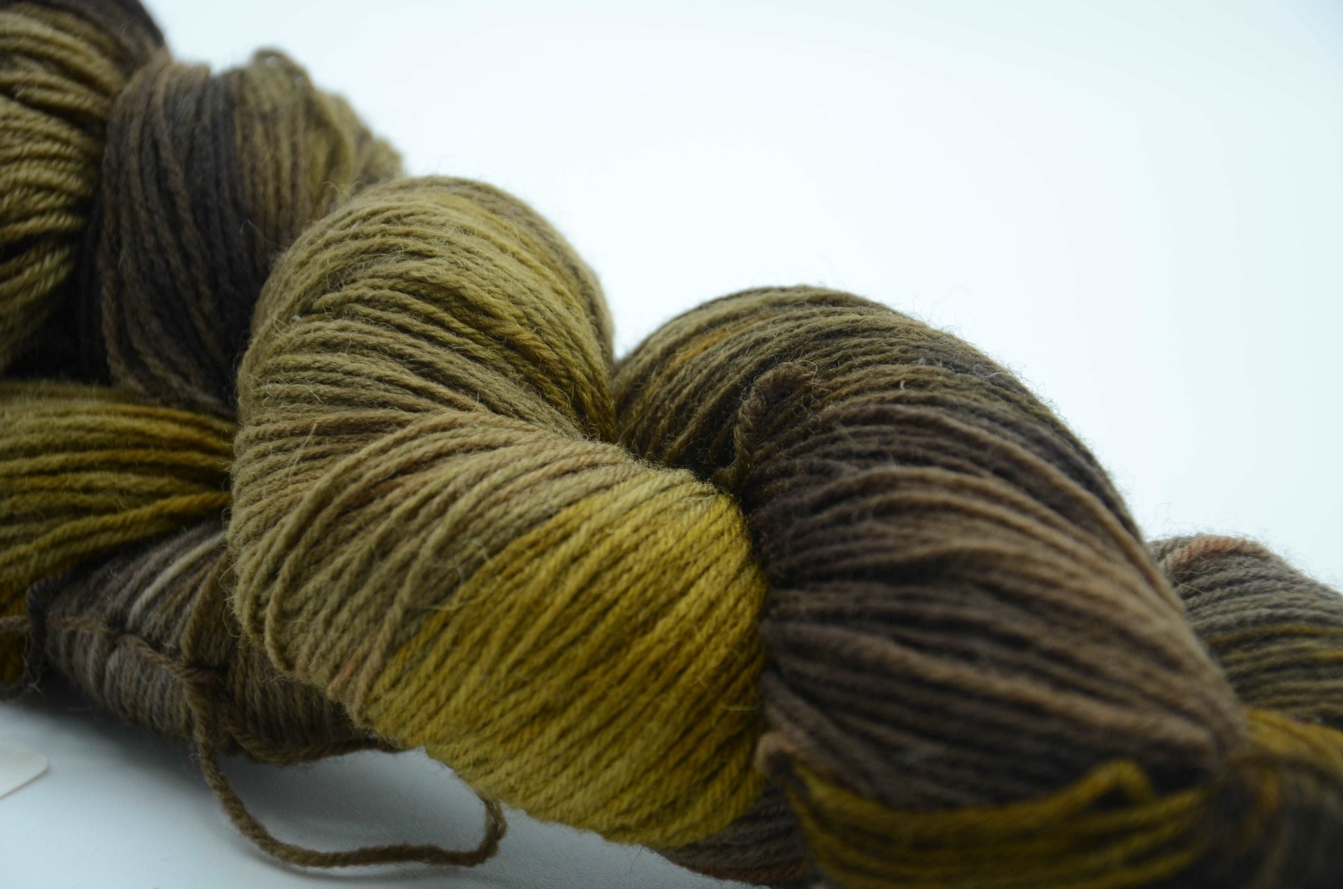 olive colored hand painted and hand dyed knitting yarn with notes of dark army green