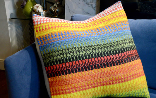 Handwoven throw pillow cover with bright and summer like warm tones of yellow, orange, green and blue