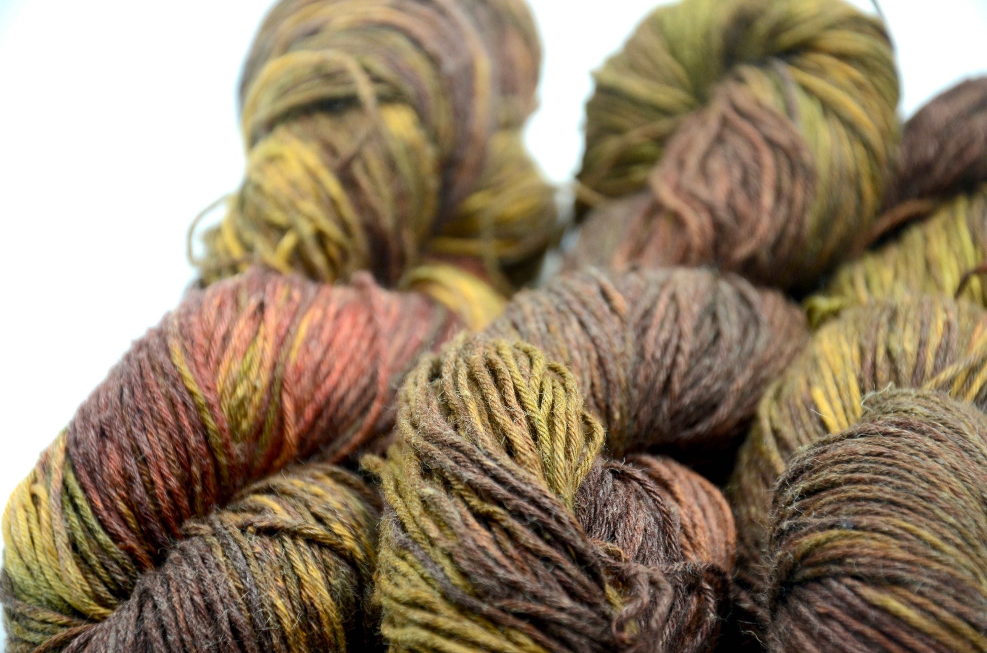 dark toned hand painted and hand dyed knitting yarn with notes of green and dark red