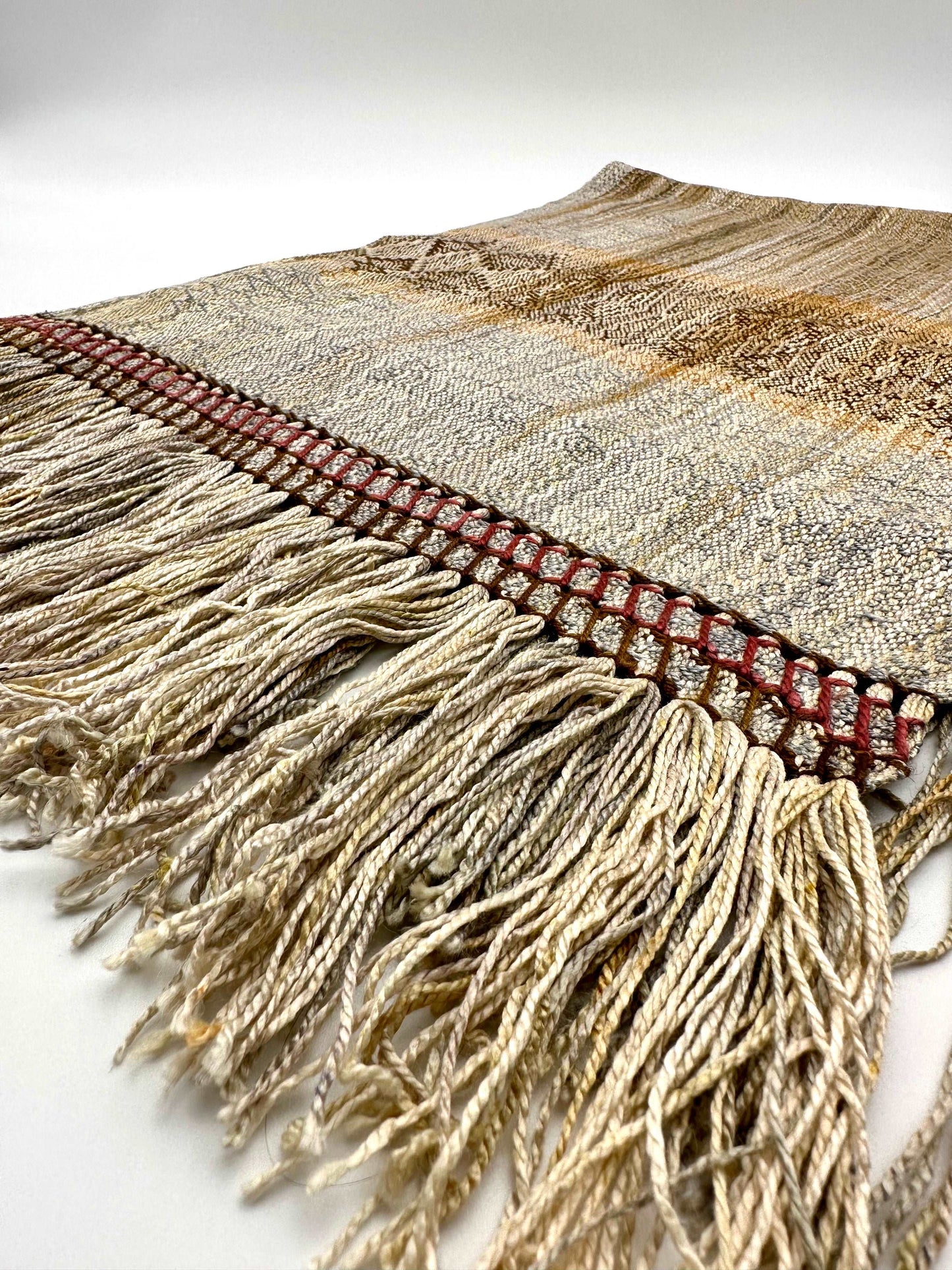 neutral colored womens handwoven scarf with notes of red and yellow