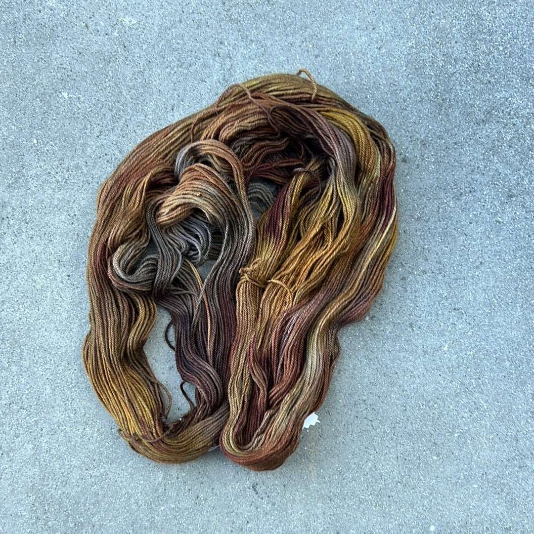 warm toned hand painted and hand dyed knitting yarn with tones of brown