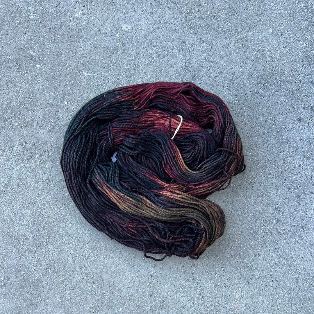 dark toned hand painted and hand dyed knitting yarn with navy and dark burgandy