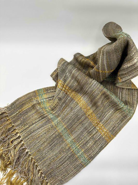 light brown colored womens handwoven scarf with notes of golden yellow and turquoise