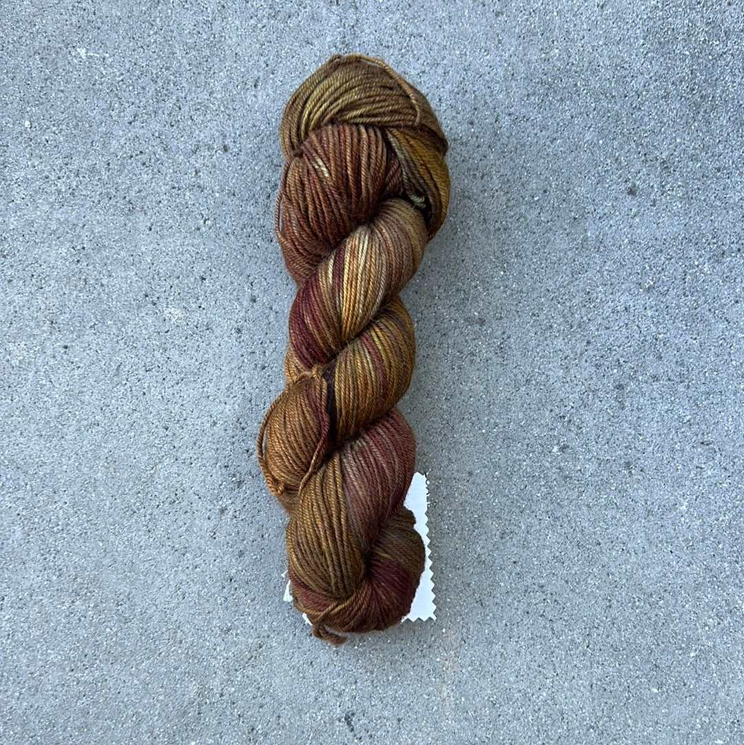 warm toned hand painted and hand dyed knitting yarn with tones of brown