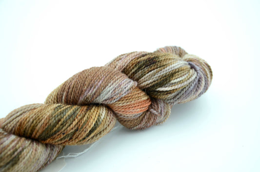 neutral toned hand painted and hand dyed knitting yarn with coral notes
