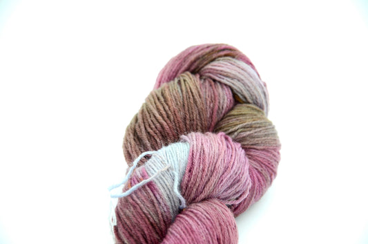 hand dyed and hand painted knitting yarn with notes of dirty pink and light blue