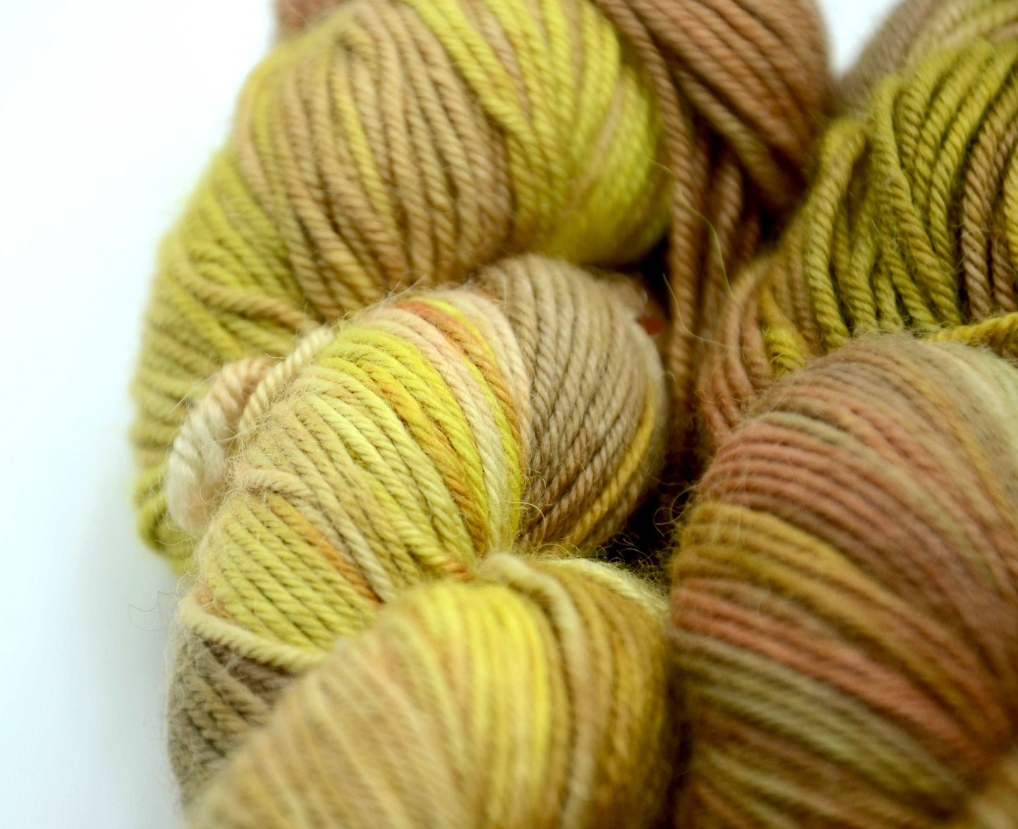 yellow toned hand painted and hand dyed knitting yarn with coral and orange notes