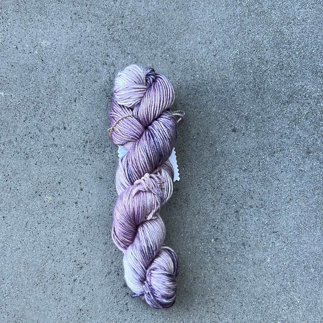 light purple and lavendar colored hand painted and hand dyed knitting yarn with notes of dark purple