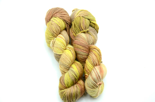 yellow toned hand painted and hand dyed knitting yarn with coral and orange notes