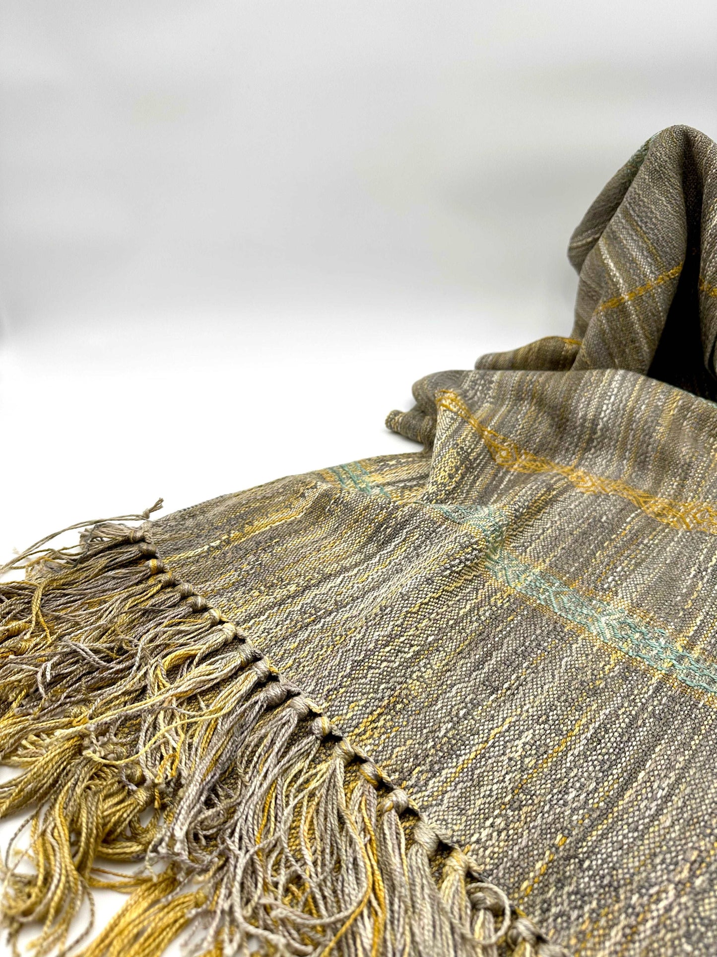 light brown colored womens handwoven scarf with notes of golden yellow and turquoise