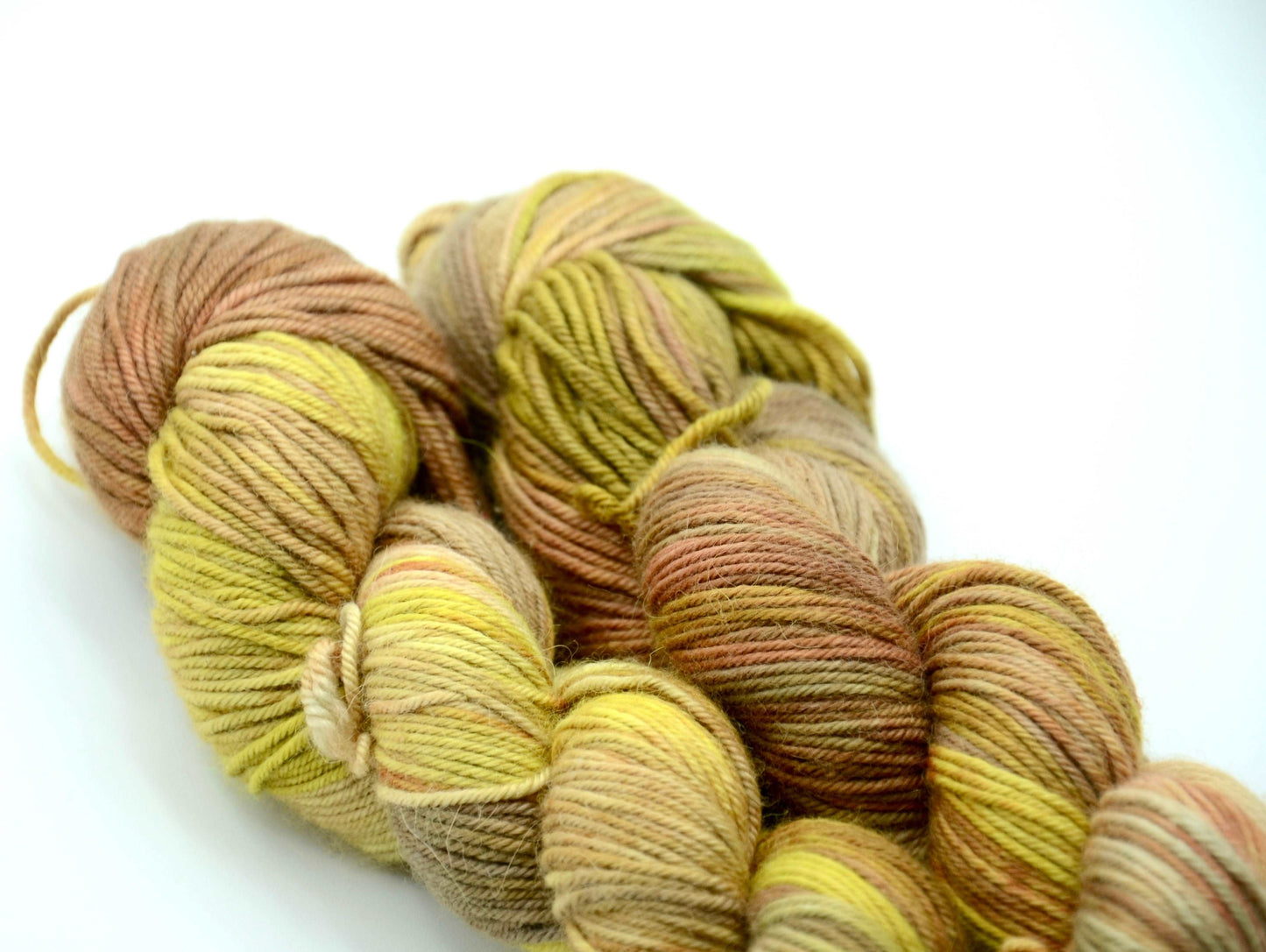 yellow toned hand painted and hand dyed knitting yarn with coral and orange notes