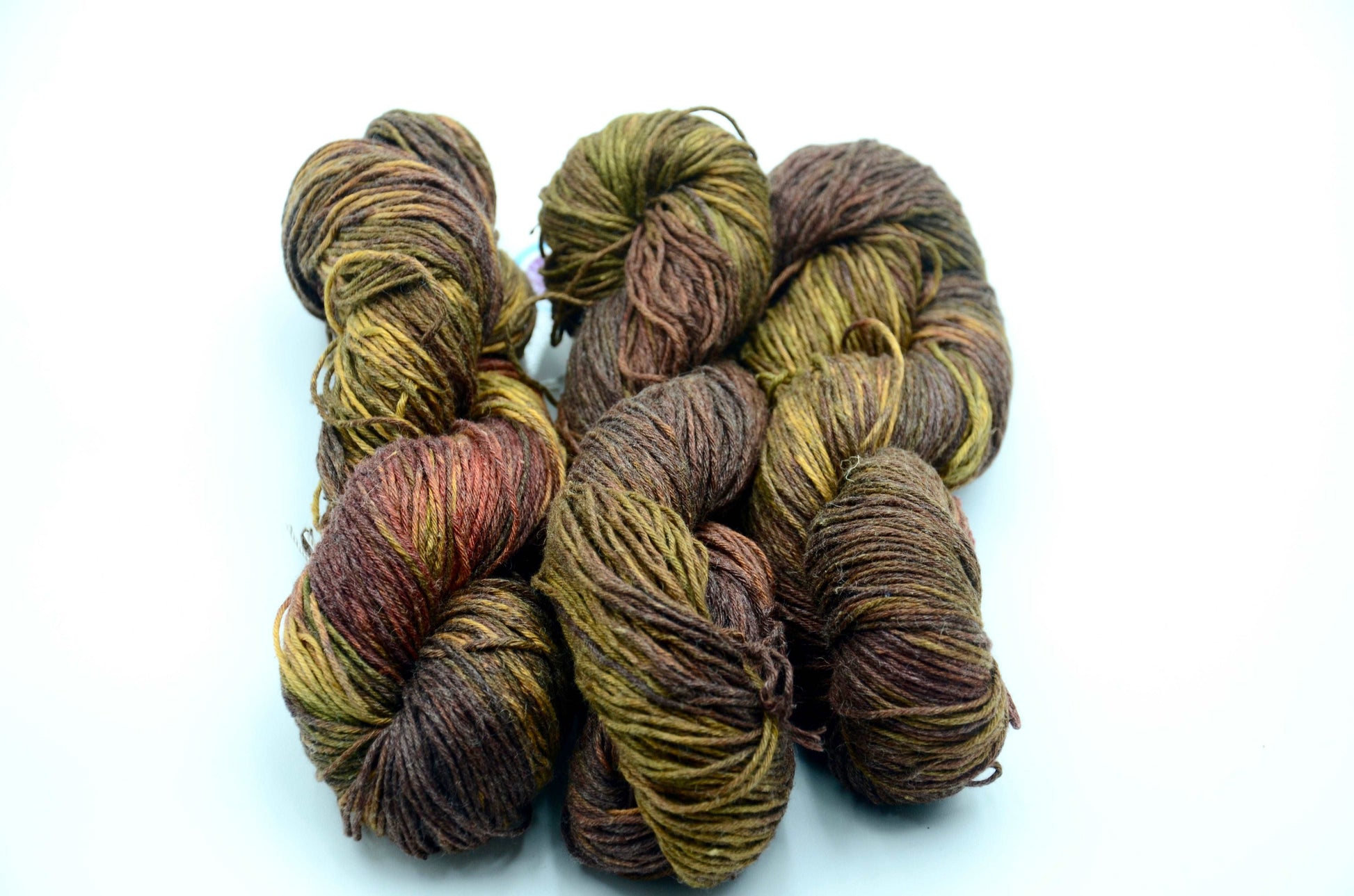 dark toned hand painted and hand dyed knitting yarn with notes of green and dark red