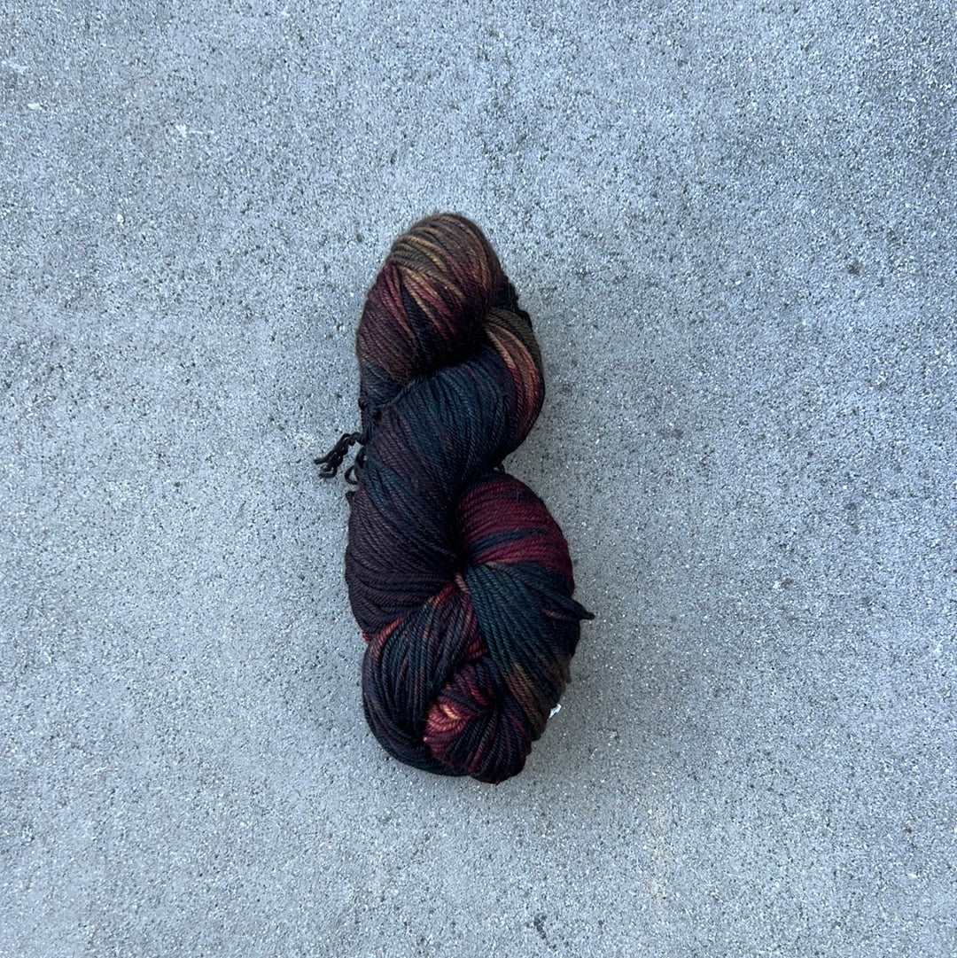 dark toned hand painted and hand dyed knitting yarn with navy and dark burgandy