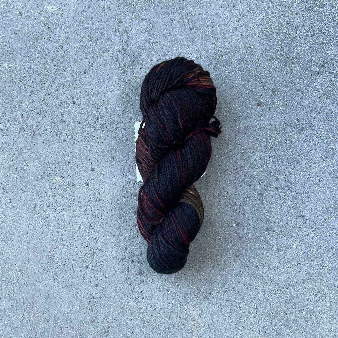 dark toned hand painted and hand dyed knitting yarn with navy and dark burgandy