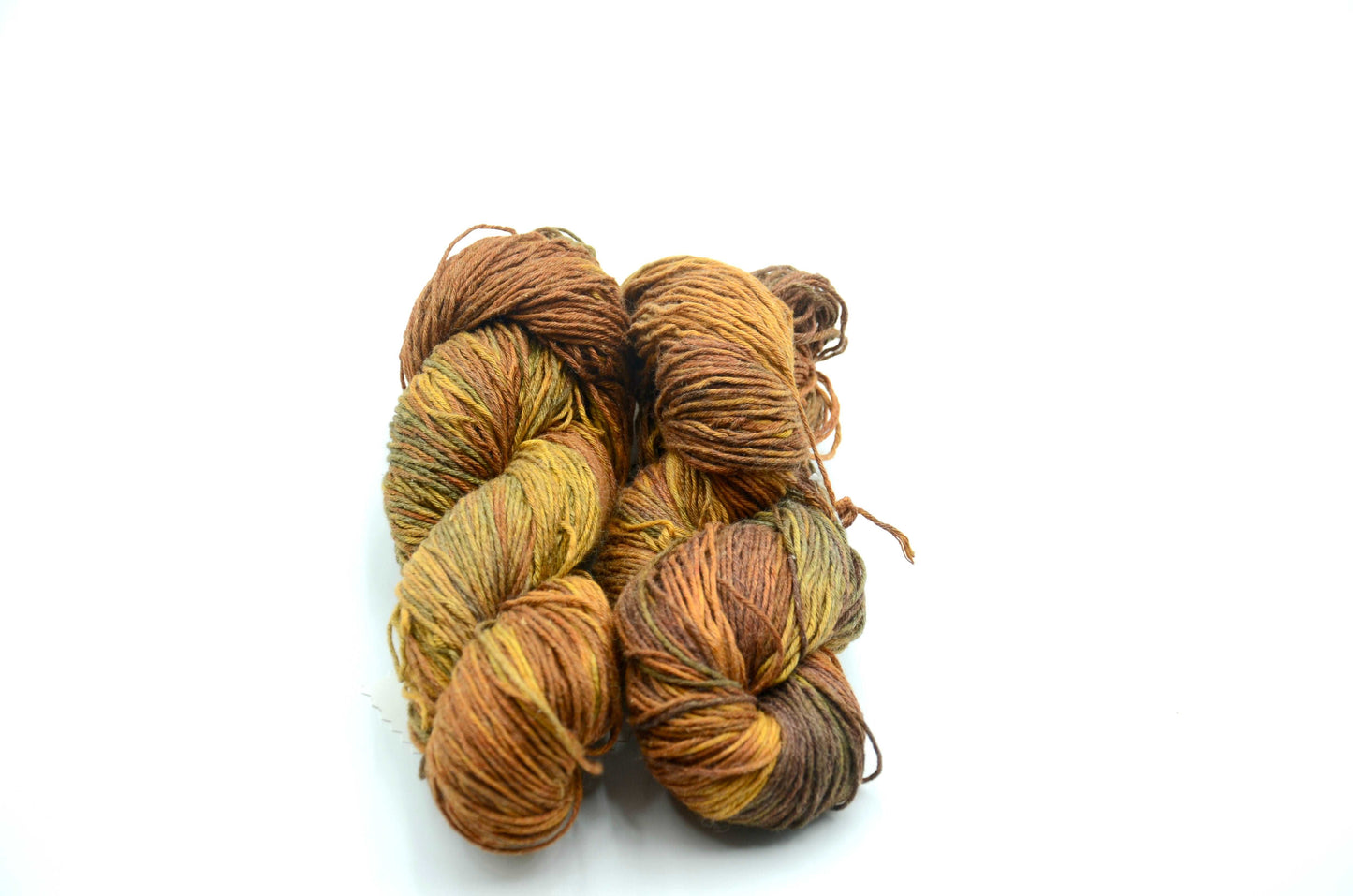 warm toned hand dyed and hand painted knitting yarn with notes of golden yellow and warm brown