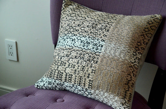 Neutral toned beige handwoven pillow cover with black weave details