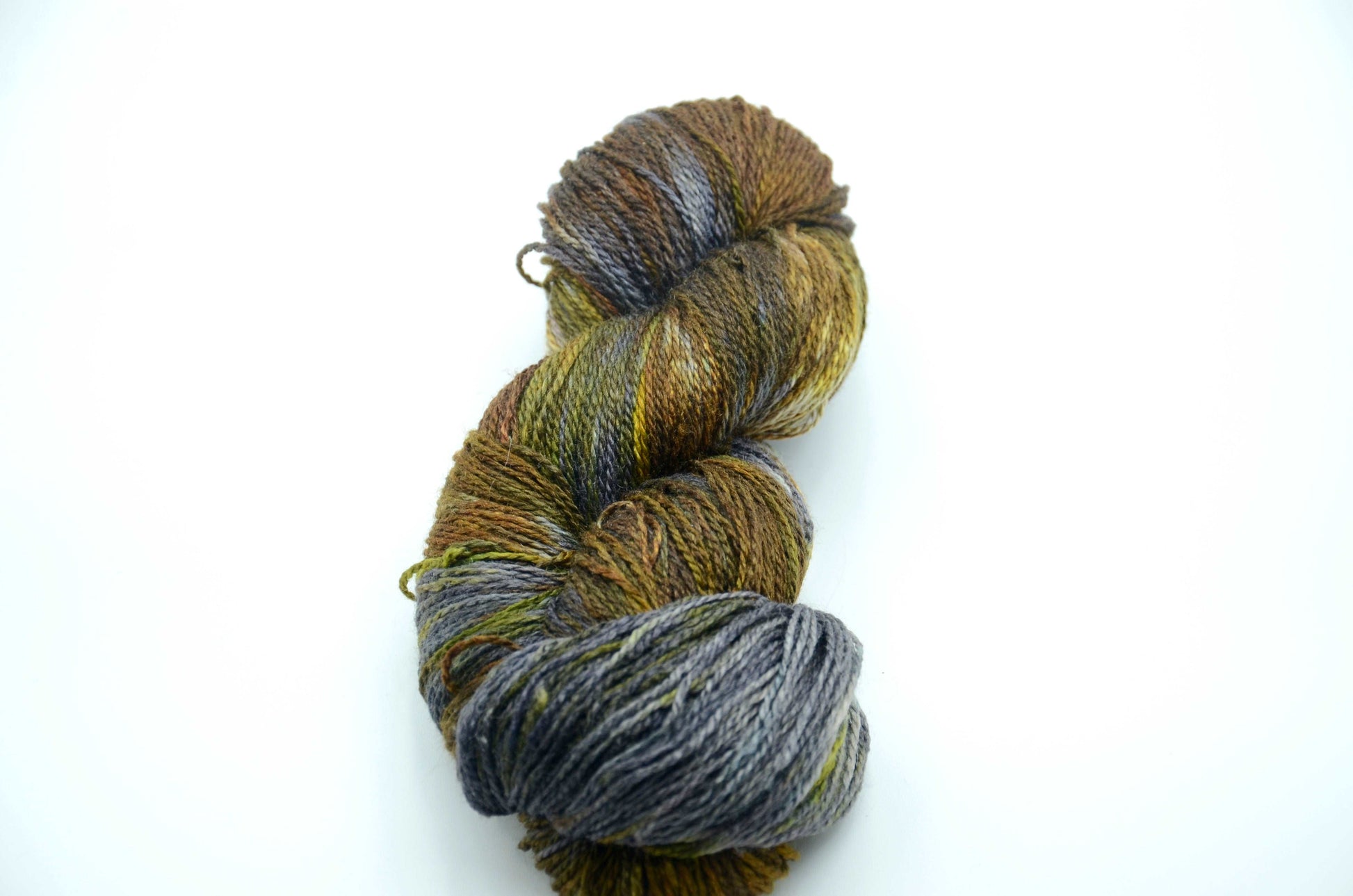 hand dyed and hand painted knitting yarn with tones of gray, dark army green and golden yellow