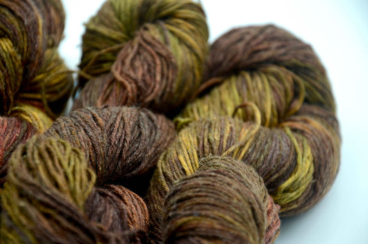 dark toned hand painted and hand dyed knitting yarn with notes of green and dark red