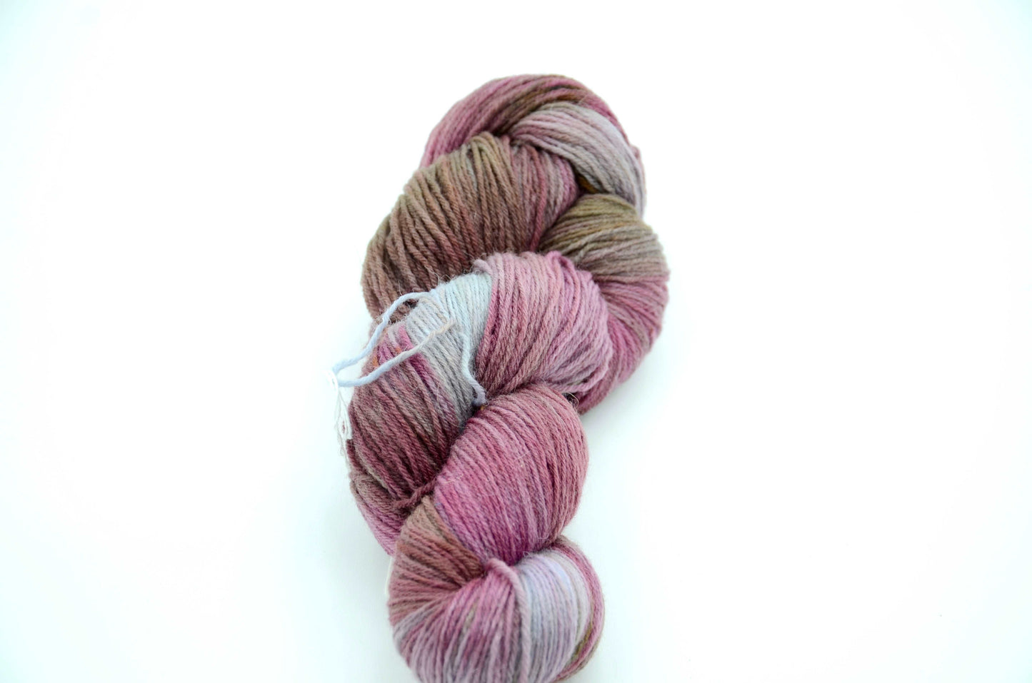 hand dyed and hand painted knitting yarn with notes of dirty pink and light blue