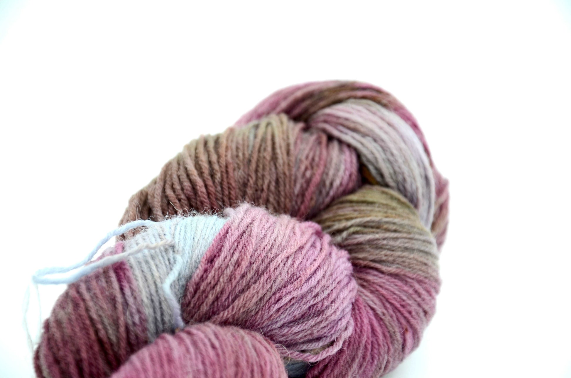 hand dyed and hand painted knitting yarn with notes of dirty pink and light blue