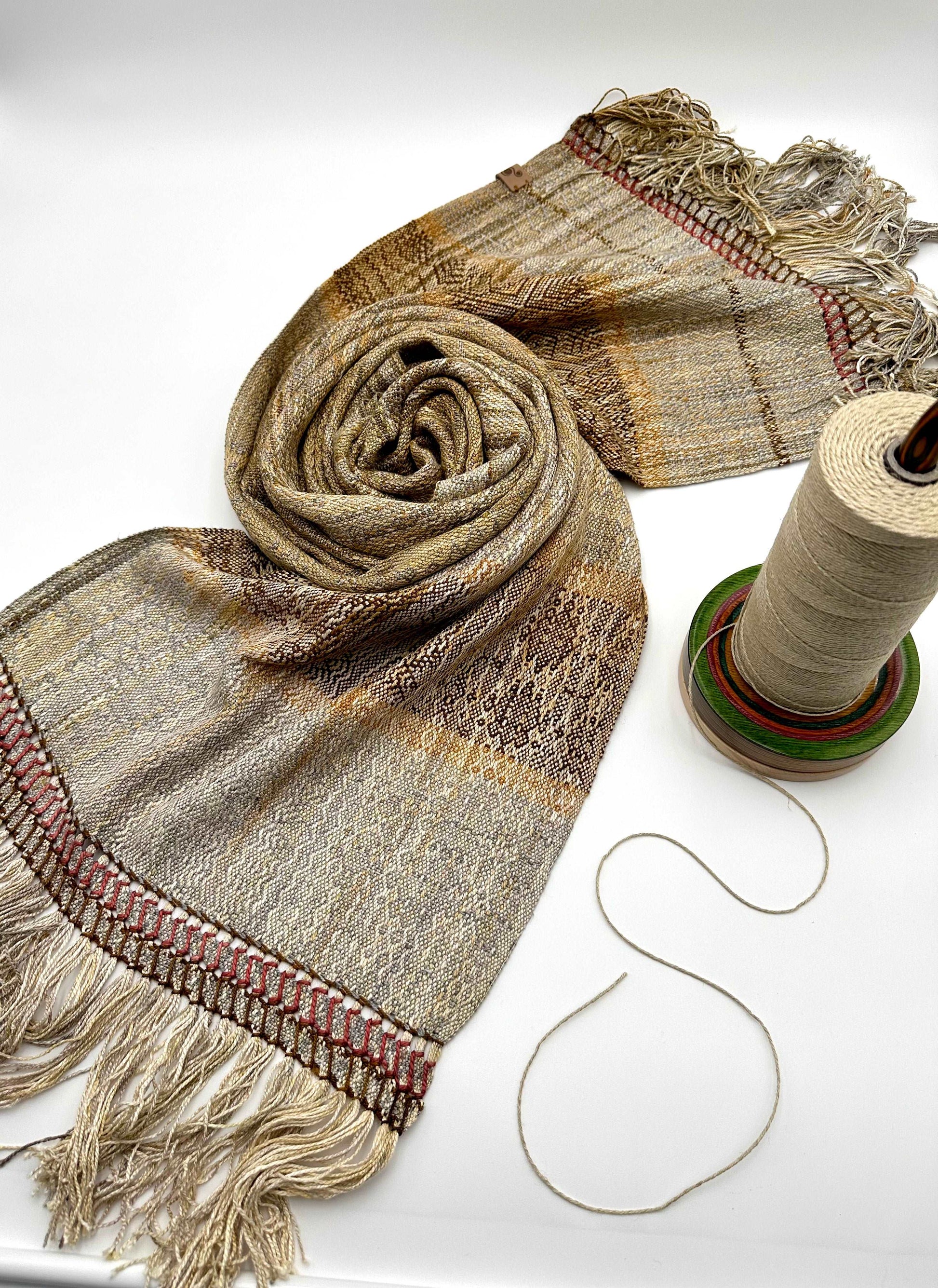 neutral colored womens handwoven scarf with notes of red and yellow