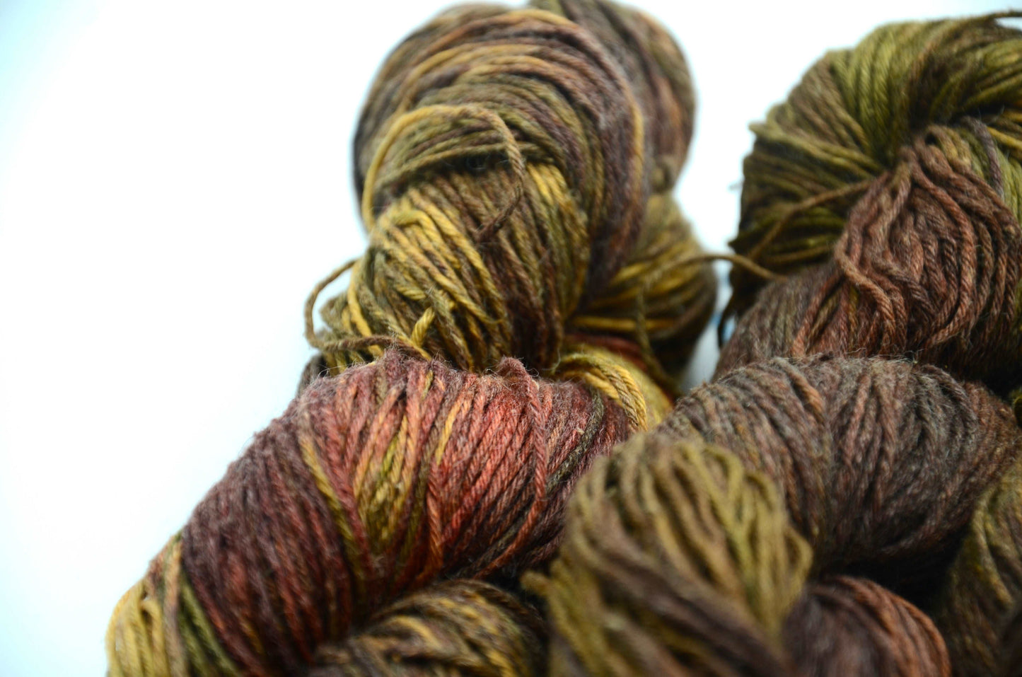 dark toned hand painted and hand dyed knitting yarn with notes of green and dark red