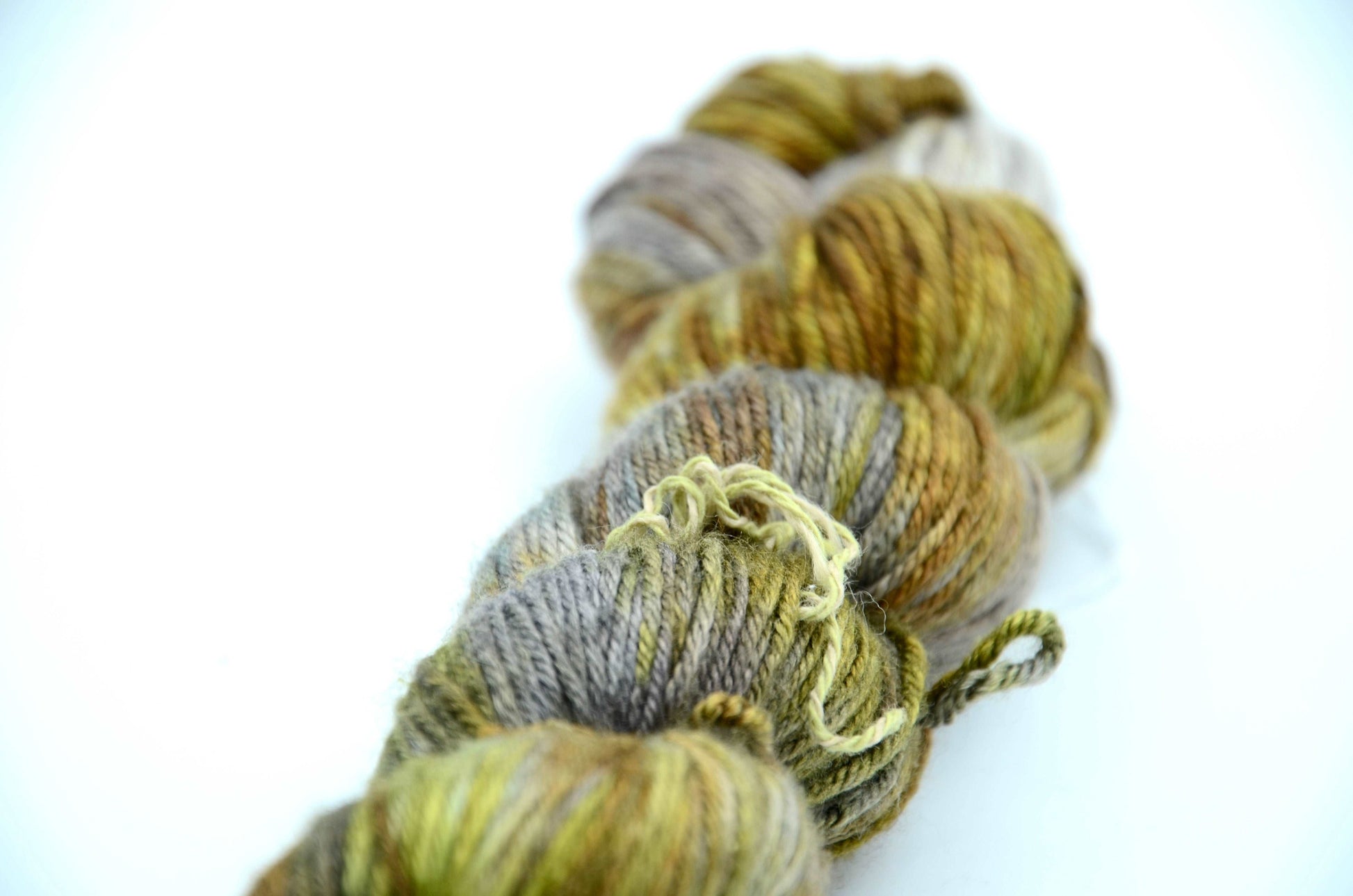 hand dyed and hand painted knitting yarn tones of light green and gold