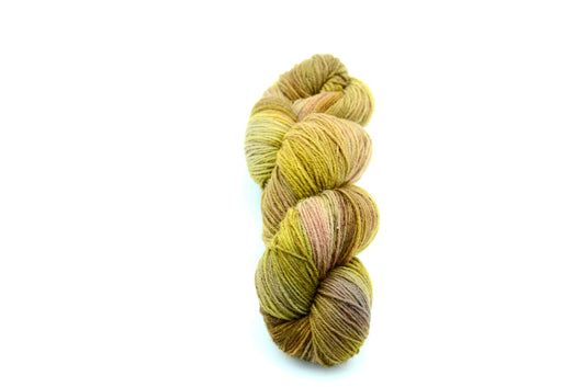 golden green hand painted and hand dyed knitting yarn with notes of brown, coral and beige